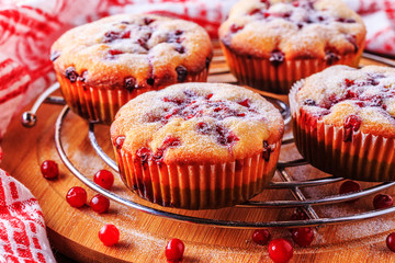 Cranberry muffins on a wooden background.