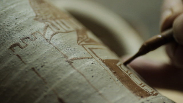 Artist Painting on a Ceramic Plate
