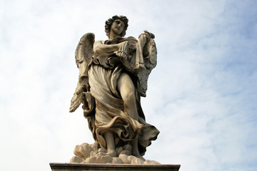 Fototapeta na wymiar Bernini's angel along the Holy Angel bridge near the Hadrian Mausoleum in Rome, Italy 