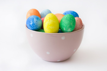 Traditional Easter eggs in a bowl. Isolated photo
