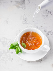 Water flowing in cup of tea.