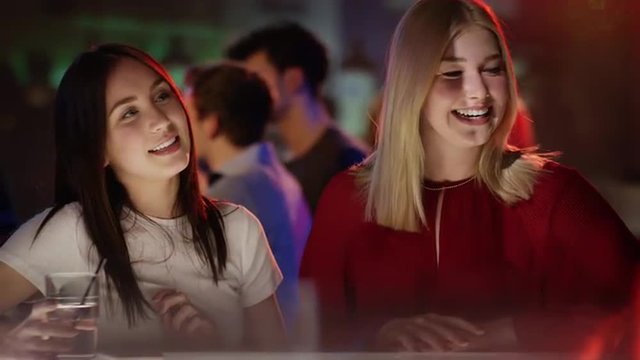 two young women ordering drinks in bar