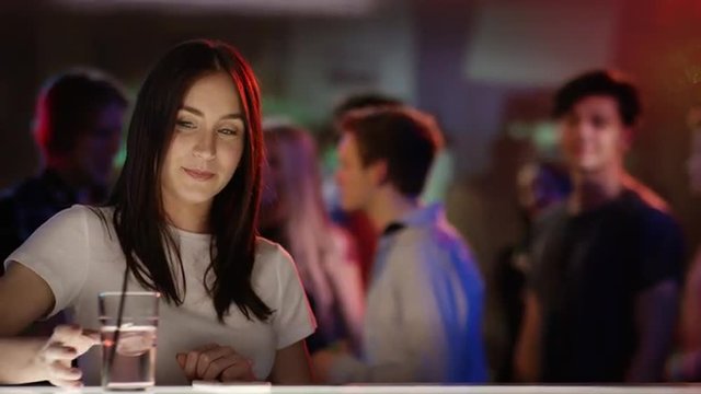 Young man checking out woman at bar