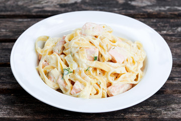 tasty pasta with salmon, dill on plate