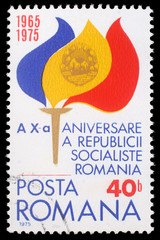 Stamp from Romania shows Torch with Flame in Flag Colors and Coat of Arms, commemorating 10th anniversary of Romanian Socialist Republic, circa 1975