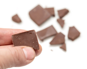 chocolate in his hand on a white background