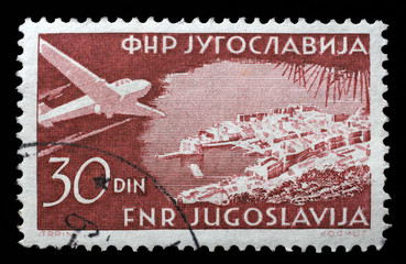 Stamp printed in the Yugoslavia shows Plane over Dubrovnik, circa 1951