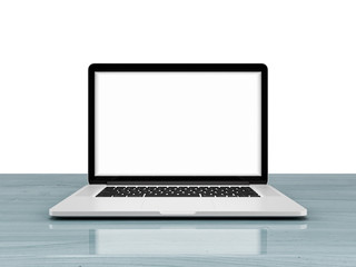 Laptop with blank screen isolated on white background, white aluminium body on blue wooden desk.