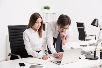 Businessman and businesswoman in office