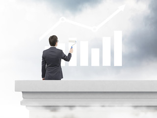 Businessman painting bar chart