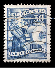 Stamp printed in Yugoslavia shows woman with books in publishing, domestic economy Series, circa 1952