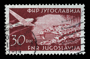 Stamp printed in the Yugoslavia shows Plane over Dubrovnik, circa 1951