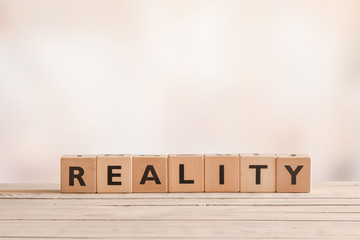 Reality sign on a table of wood