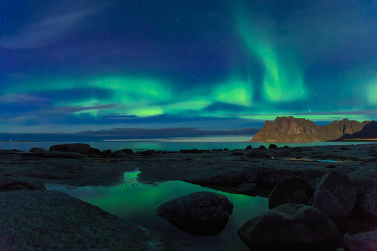 Aurora over the sea at Utakleiv beach, Lofoten Islands, Norway © aiisha