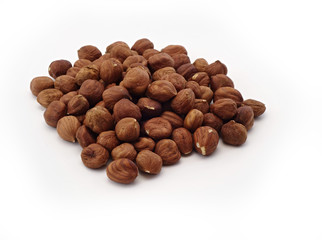 scattered hazelnuts on a white background