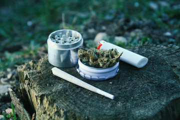 Marijuana Buds With Joint, Lighter And Grinder