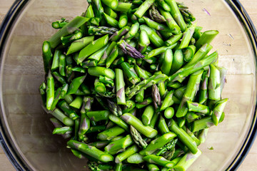 A bowl of  trimmed and sliced raw asparagus
