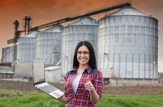 Girl With Laptop In Front Of Silo