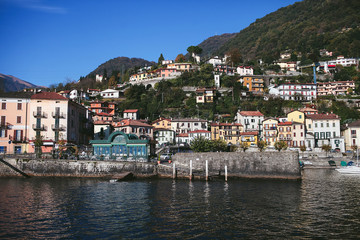 Fototapeta na wymiar view from the water to the house on the shore of a mountain lake Como