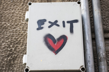 Graffiti exit sign with a red heart