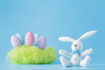 Colorful Easter egg over blue paper background