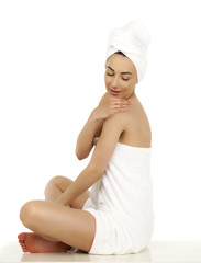 Young woman wrapped towel isolated on white background