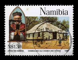 Stamp printed in Namibia shows Archbishop Joseph Gotthardt, Ovamboland old church and school, circa...