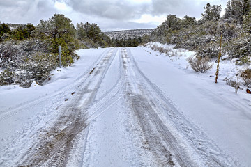 Snow covered road winter tire track dangers