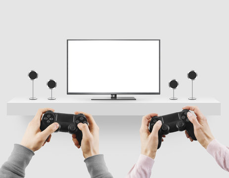 Man hold gamepad in hands in front of blank tv screen mock up player.