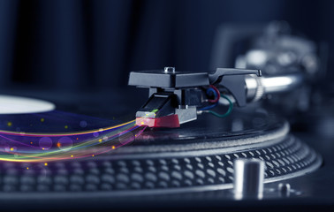 Fototapeta na wymiar Turntable playing vinyl with glowing abstract lines
