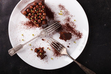 Piece of chocolate cake  on a dark background.selective focus.