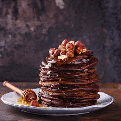 Chocolate pancake with honey and hazelnuts.selective focus