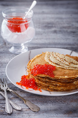 Pancakes with red caviar.Carnival.selective focus.