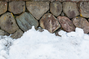 stone wall with snow pile