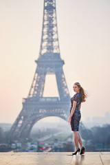 Beautiful elegant Parisian woman near the Eiffel tower