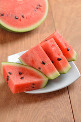 slices of watermelon on wooden background