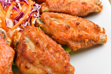 Buffalo chicken wings on white plate wooden background
