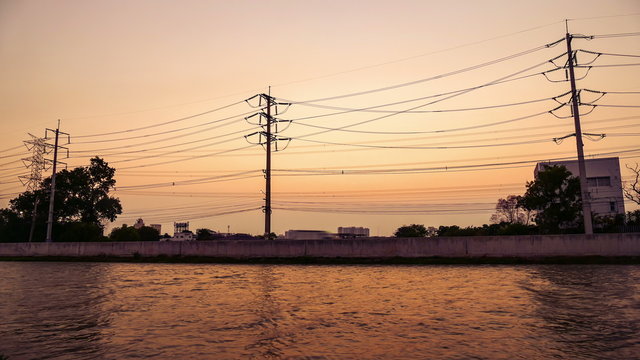Water in front of High voltage electricity pylon at sunset, Time lapse:Ultra HD 4K High quality footage size (3840x2160)