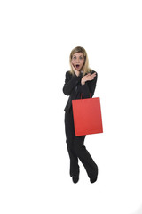 Fototapeta premium young happy beautiful woman in business suit in excited face expression holding red shopping bag