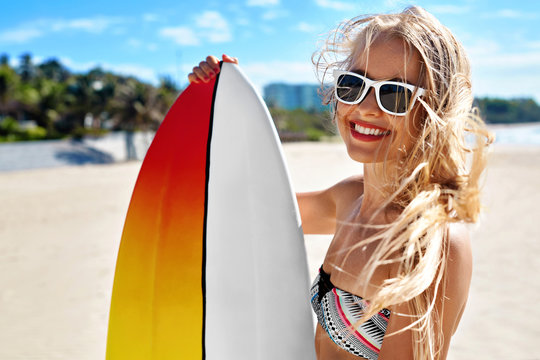Summer Travel Beach Vacation. Close Up Of Healthy Happy Beautiful Sexy Woman In Sunglasses With Surfboard Having Fun By Sea. Active Lifestyle. Leisure Sporting Activity. Water Sports. Summertime Relax
