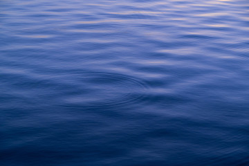 ripple of blue water surface in the lake with circle wave water