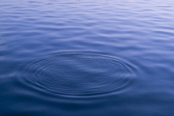 ripple of blue water surface in the lake with circle wave water