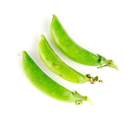 Three pods of sugar snap legumes on white