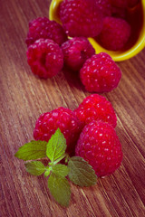 Vintage photo, Fresh raspberries and lemon balm on wooden surface, healthy food