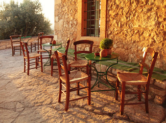 Fototapeta na wymiar traditional greek country outdoor restaurant on terrace with emp
