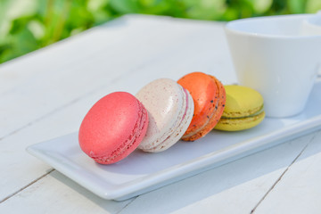 macaroon multicolored  with a cup of coffee