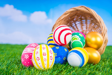 Easter Eggs on Fresh Green Grass over blue sky