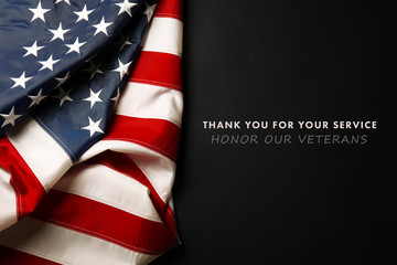 Text Thank You For Your Service on black background near American flag