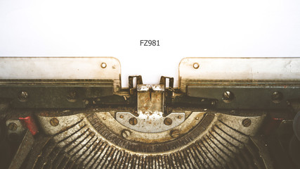 Fototapeta na wymiar Typewriter and empty white paper with a word FZ981, vintage styl
