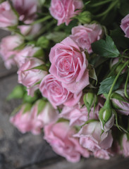 Bouquet of pink roses on vintage wooden floor